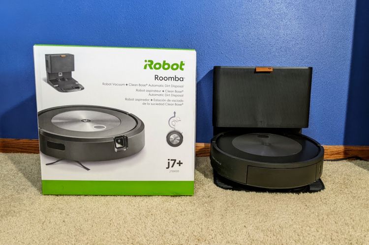 The iRobot Roomba j7 and clean base with box nearby