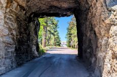 View through a tunnel from Iron Mountain Road in the Black Hills. Through the tunnel you can see Mt. Rushmore. Copyright 2026 by Bryan Ruby